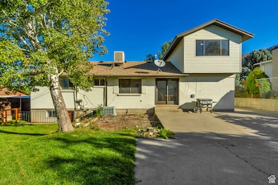 Rear view of property with brick siding and roof with shingles