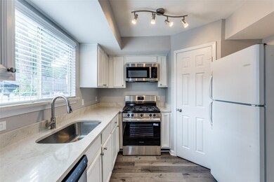 Kitchen featuring stainless steel appliances, whi