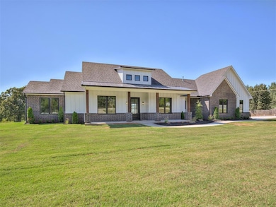 View of front of property featuring a shingled roo