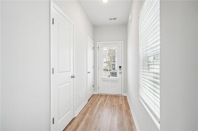 Entryway with light wood-type flooring, visible ve