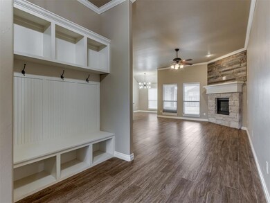 Mudroom featuring ceiling fan with notable chandel