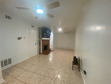 Bonus room featuring light tile patterned floors and a large fireplace