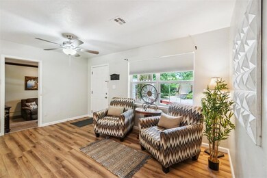 Living area featuring wood finished floors and ceiling fan