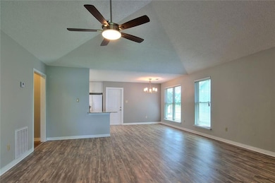 Living room facing dining area with kitchen to the