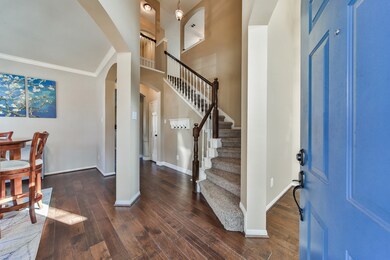 Two story formal entry with rich hardwood floors.