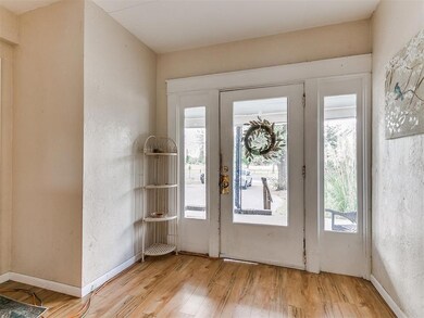 Doorway with light hardwood / wood-style floors an
