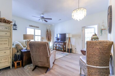 Living room with light hardwood / wood-style floor