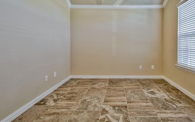 Empty room featuring crown molding and tile flooring