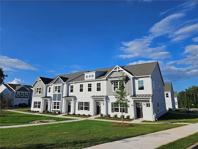 View of front of property featuring a standing seam roof, a front yard, a metal roof, and board and batten siding