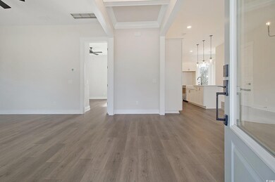 Unfurnished living room with sink, light hardwood 
