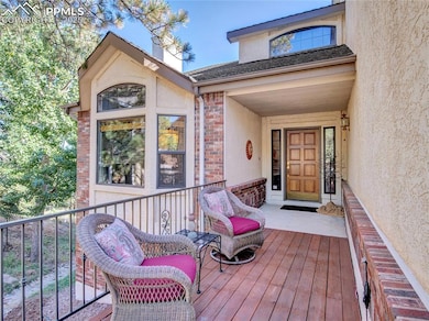 Property entrance featuring brick siding, stucco s