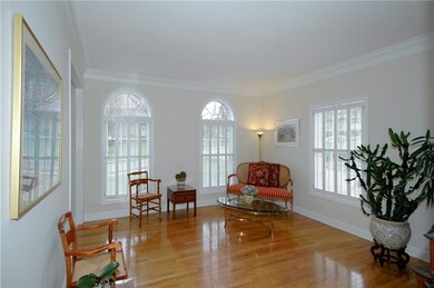 Living Room - Hardwood floors, crown molding, and 