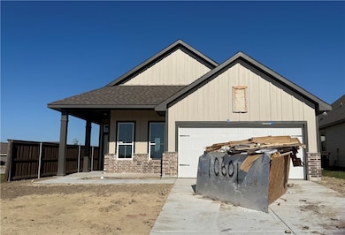 View of front facade with a porch, a shingled roof, concrete driveway, and a garage