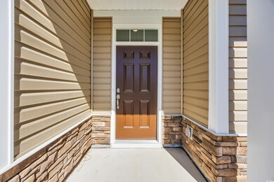 View of exterior entry featuring stone siding