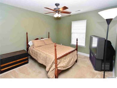 ALL WINDOWS IN THE HOUSE HAVE TWO-INCH PLANTATION BLINDS. THIS BEDROOM OFFERS CARPETING AND A CEILING FAN.