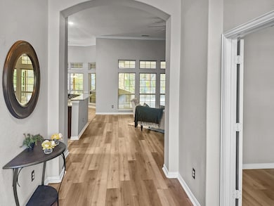 Hall featuring crown molding and light wood-type f