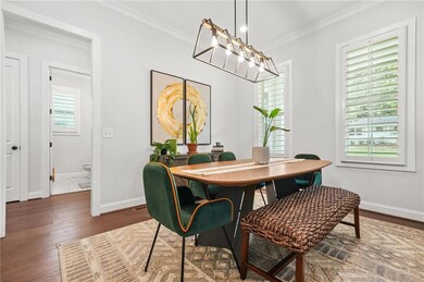 Dining space featuring ornamental molding, baseboards, and hardwood / wood-style floors