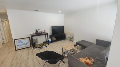 Living room with wood finished floors and recesse