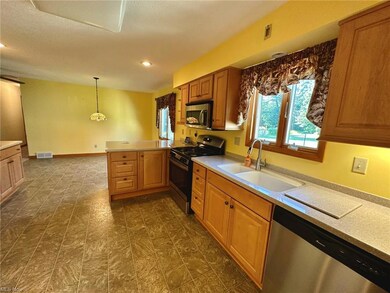 Kitchen with a textured ceiling, hanging light fix