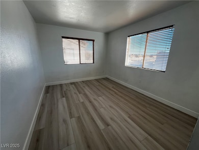 Spare room with light wood-type flooring, baseboar