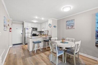 Dining area featuring crown molding, baseboards, a