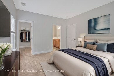 The primary bedroom is expansive and features a walk-in closet and the en suite primary bathroom.