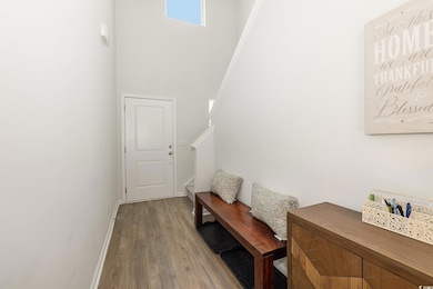 Doorway featuring wood finished floors, stairway, 
