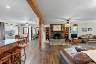 Living area featuring a ceiling fan, a fireplace,
