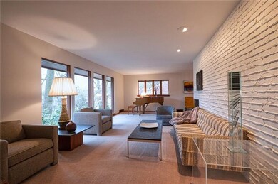 Sun pours into this spacious living room through s