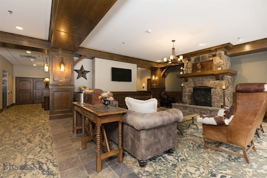 Living room featuring a stone fireplace