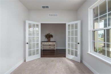 Front office/den/play/bookroom with view of foyer