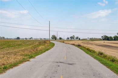 View of asphalt street with a view of rural / pastoral area