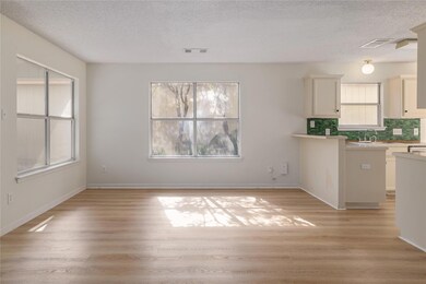 Kitchen featuring a textured ceiling, light count