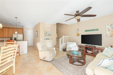 Tiled living room featuring ceiling fan and sink