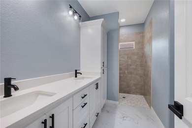 Full bath featuring a walk in shower, baseboards,