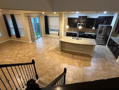 Kitchen with dark cabinetry, tasteful backsplash, open floor plan, and stainless steel appliances