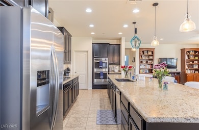 Kitchen with light stone counters, recessed lighti