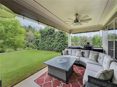 View of patio with an outdoor hangout area and ceiling fan