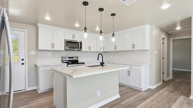 View from the kitchen looking into the bright and open living space, highlighting the stunning natural light and elegant quartz countertops.