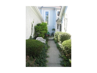 Charming landscaped entry welcomes you home.