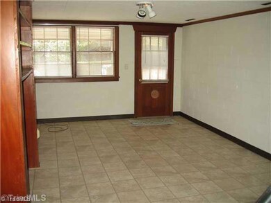 Den/Family/Great Room. This room is very large and has nice paneling on several of the walls as well as bookshelves.  You can enter this room in the basement from the kitchen area or from an outside door or from the garage.  Would make a nice playroom or in-law suite.