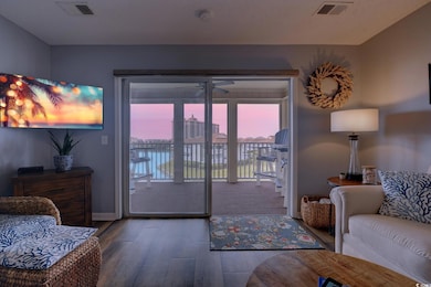 Living room featuring visible vents, baseboards, and wood finished floors