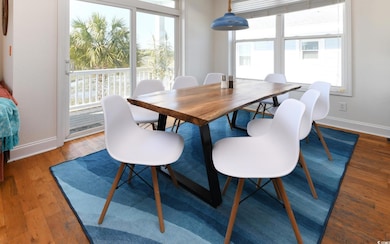 Dining room with baseboards and light wood-style flooring