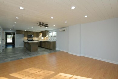 This area open to the kitchen can be used as a gathering room or dining. 