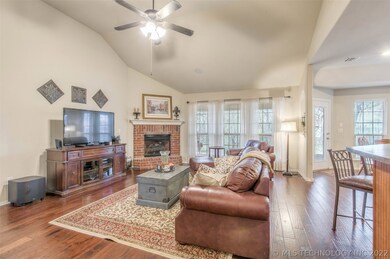 The living room features vaulted ceilings and a fi