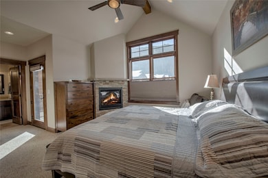 Primary bedroom suite with fireplace and sunny pri