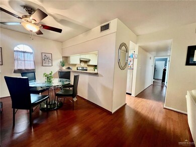 Dining space with wood finished floors, ceiling fan, and baseboards