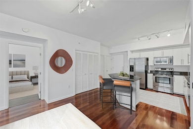 Kitchen with a center island, white cabinetry, da