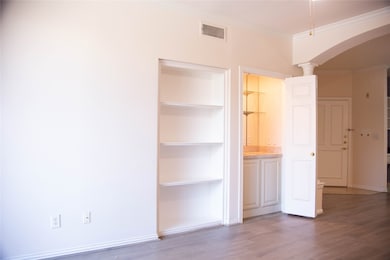 This photo shows an entryway with light-colored wa