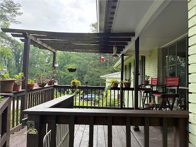 Deck with a pergola in front of the house.